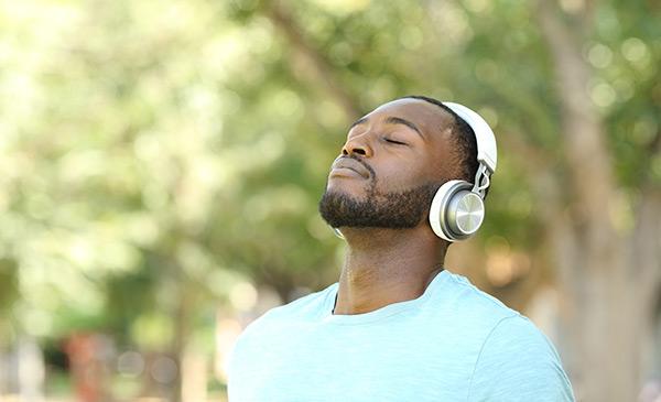 African American man listening to music and feeling relaxed