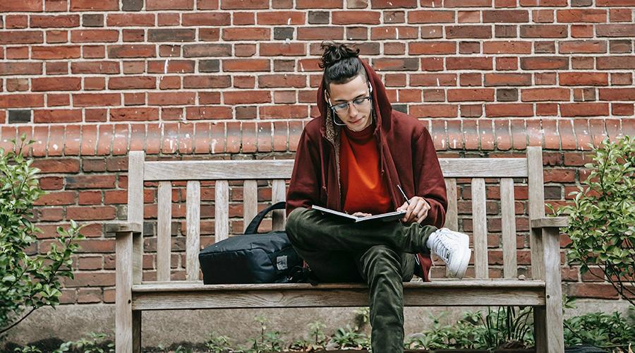 student studying on a bench
